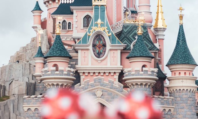 You can the distinctive roof tops of the Disneyland castles, and a blurred top of a head - someone is wearing a band with Mickey Mouse ears. The ears are red with white dots