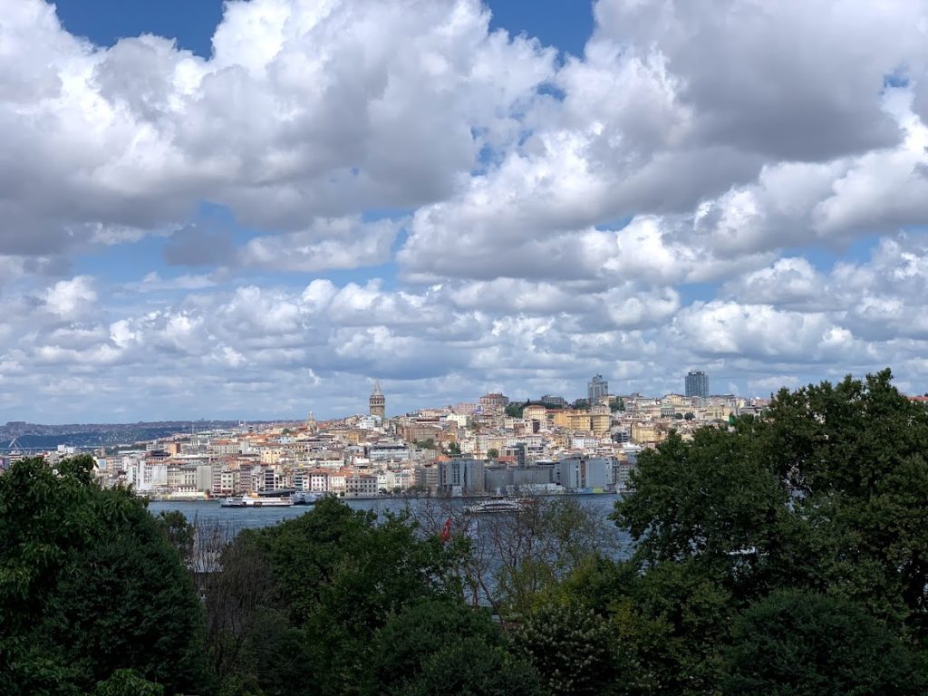 You can see the buildings and skyline of Istanbul from a terrace in the Topkapi Palace - blue skies, white fluffy clouds and the city spread out with the sea in between