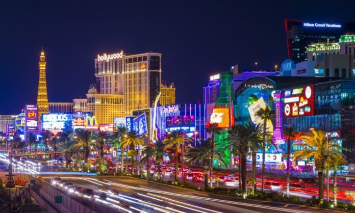 A nightscape of Las Vegas with buildings all lit up in lights - a pic from the holiday offer from Tour America