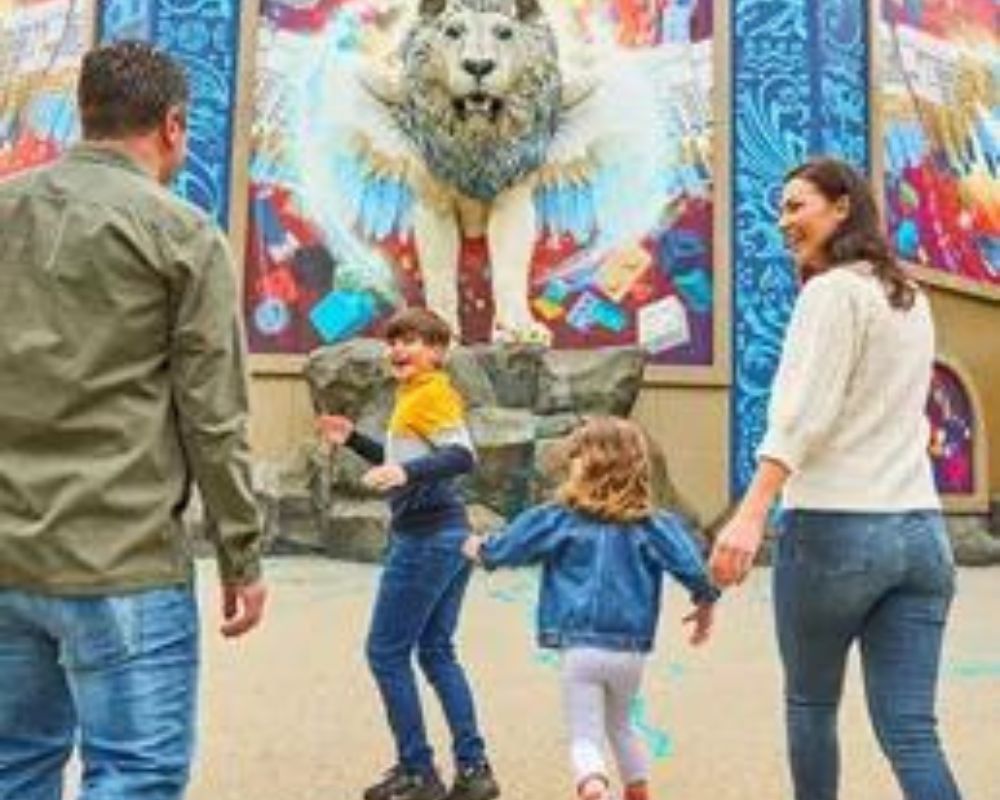 You see a family. Mother, father, two children (a girl and a boy) at Legoland Windsor. They seem to be enjoying their holiday
