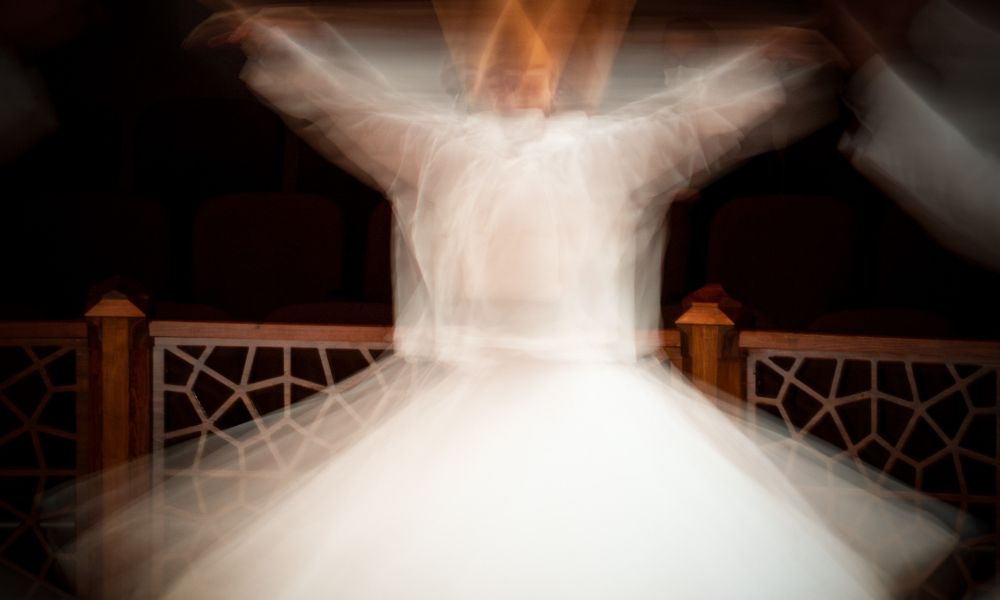 A blurred image of a dervish as he dances 