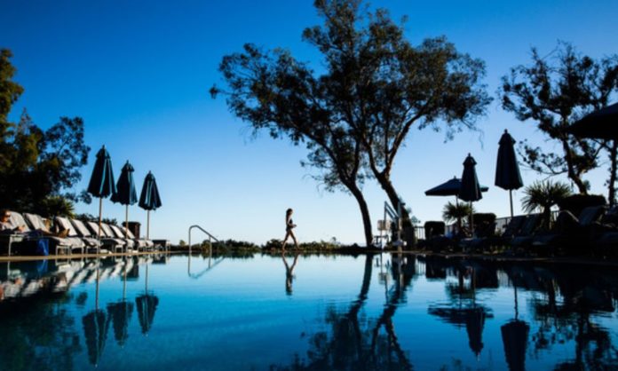A woman takes in the stunning pool and locations of a resort in California