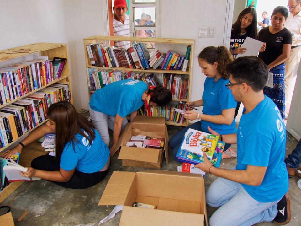 Volunteers arranging books on the floating book fair