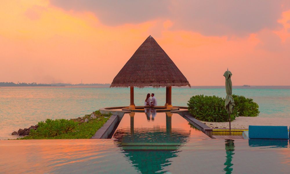A couple having a romantic moment at an infinity pool - a representative pic for Valentine's Day