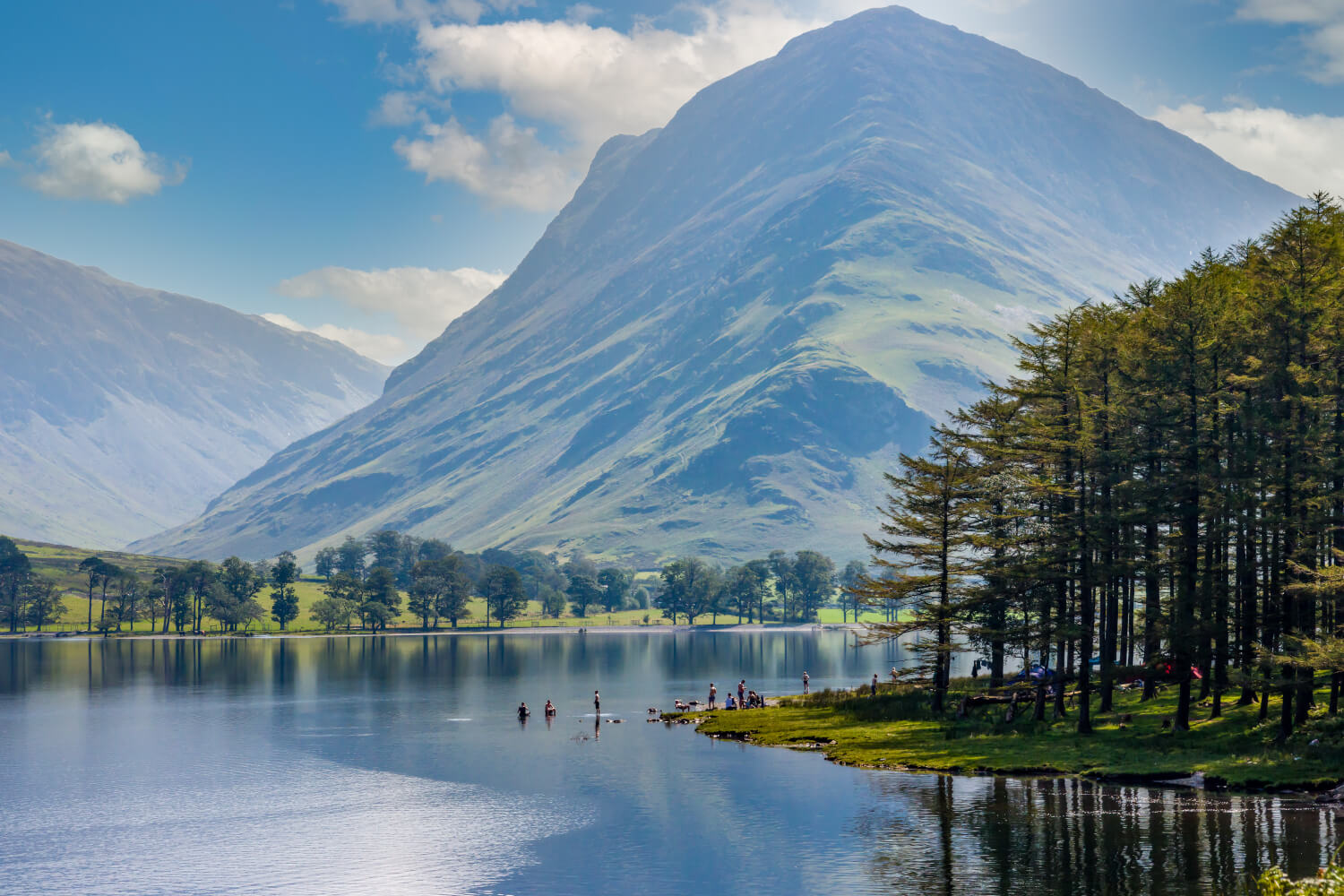 Swimmers enjoying the calm waters of Buttermere, Lake District, England