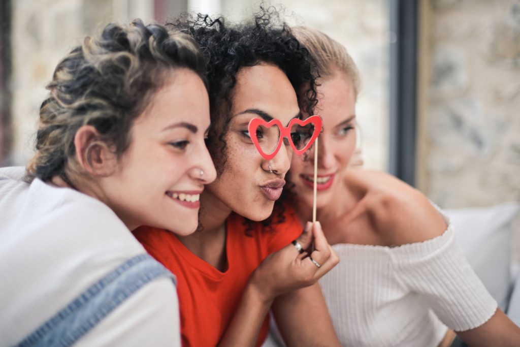 Three women huddling together - representative pic for Women's Day